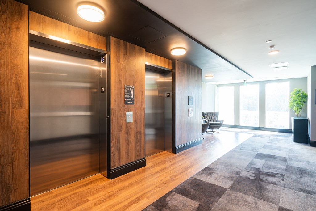 two elevators in a lobby in an office building
