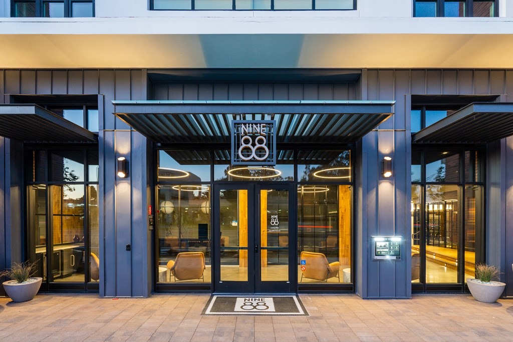 the front of a blue building with glass doors