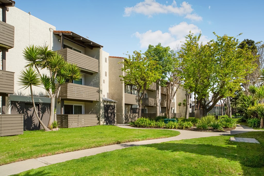 Apartment complex with a green lawn in front.