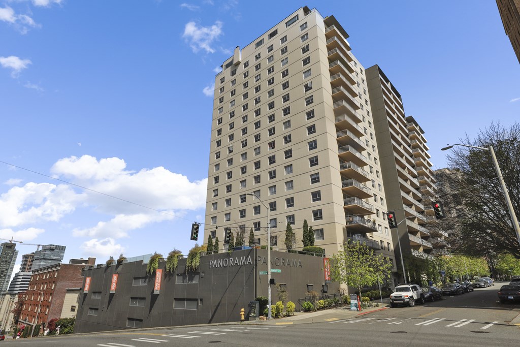 an apartment building on the corner of a city street