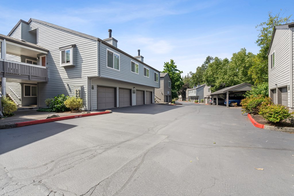the street in front of a house with a car garage