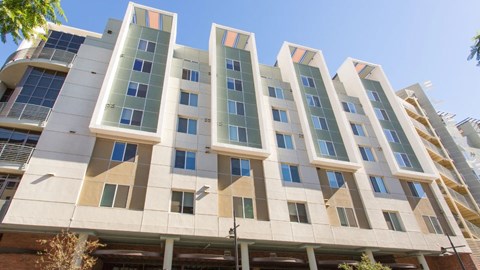 A modern building with a white facade and blue windows.