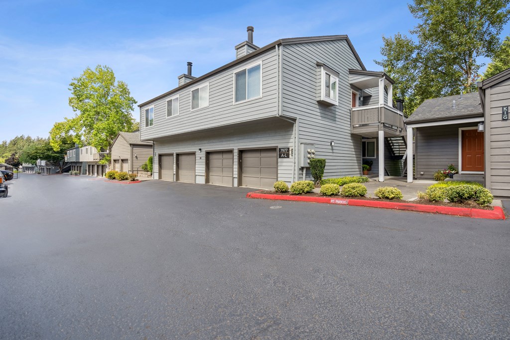 a large driveway in front of a house with a garage door