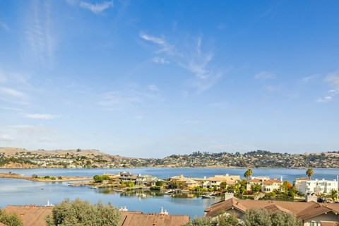 A view of a residential area with houses and a body of water.