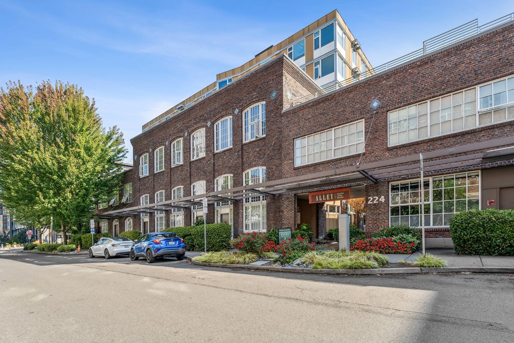 a large brick building with cars parked outside of it
