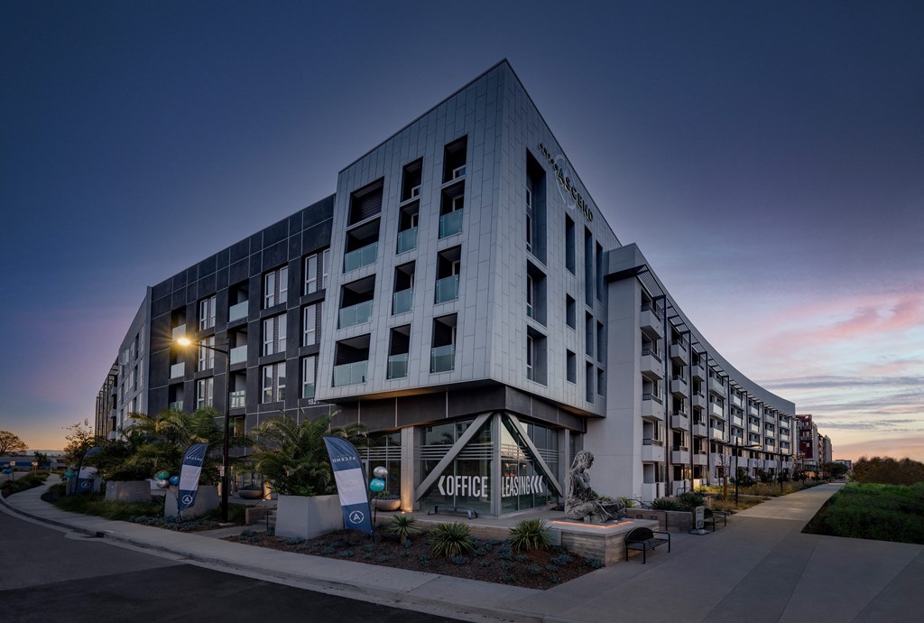 the facade of a building with a sunset in the background
