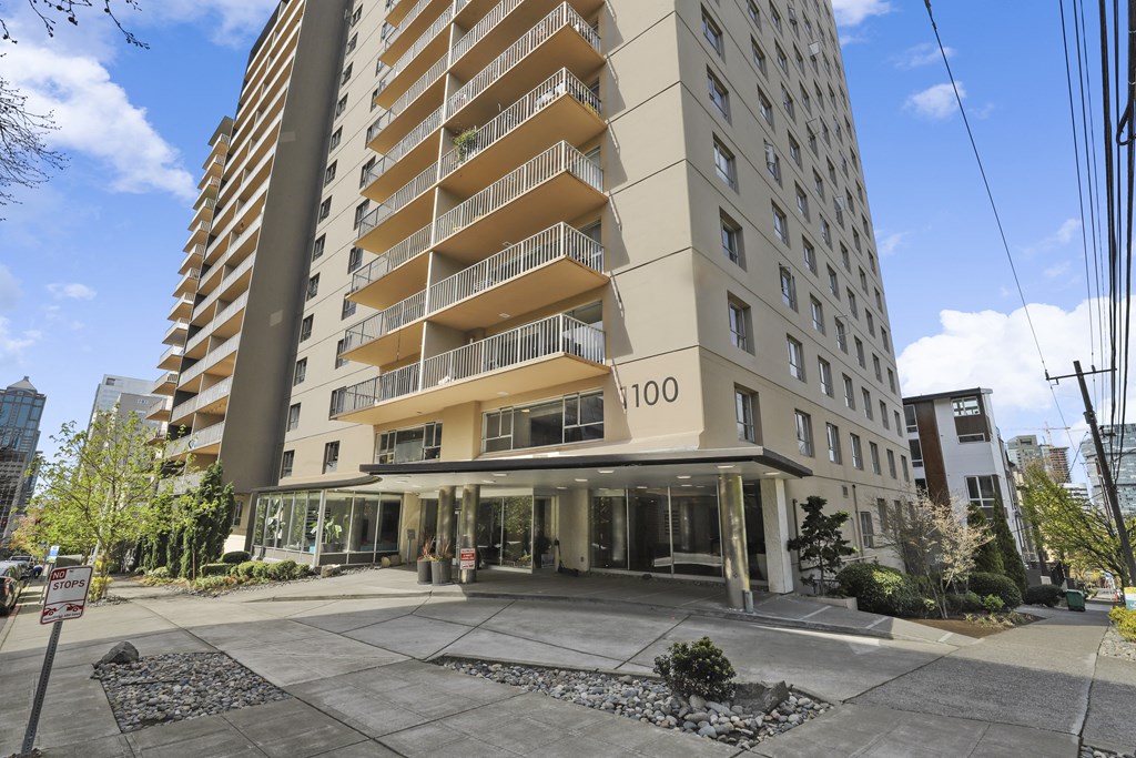 an apartment building on the corner of a city street
