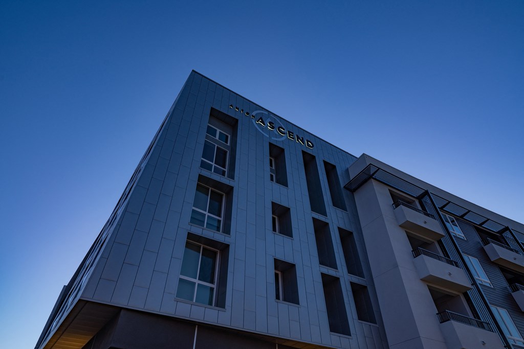 a silver building with a blue sky in the background