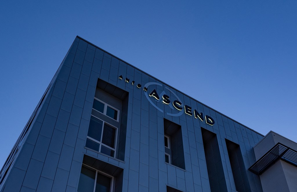 a view of the facade of a building with the word ascend on it