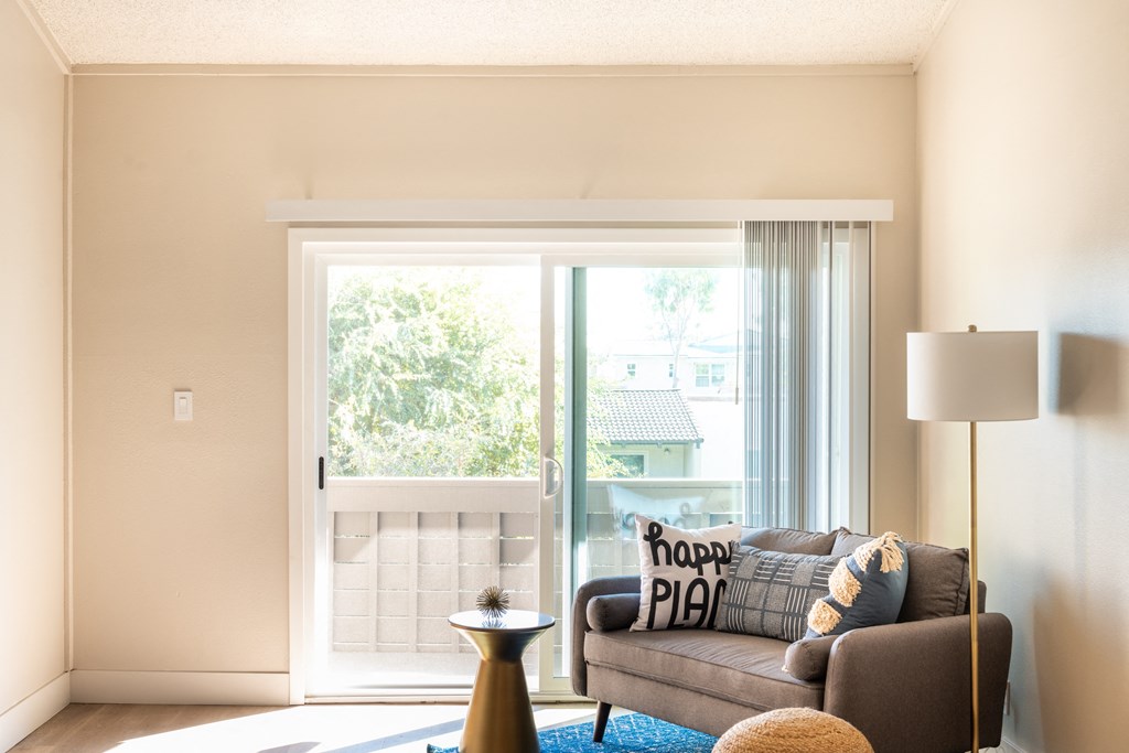a living room with a couch and a window