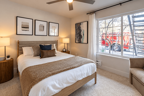 A bedroom with a large bed and a couch.