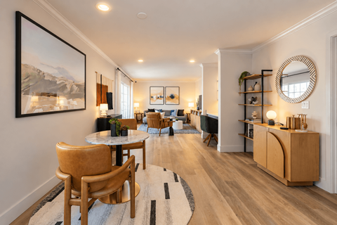 A living room with a wooden floor and furniture.