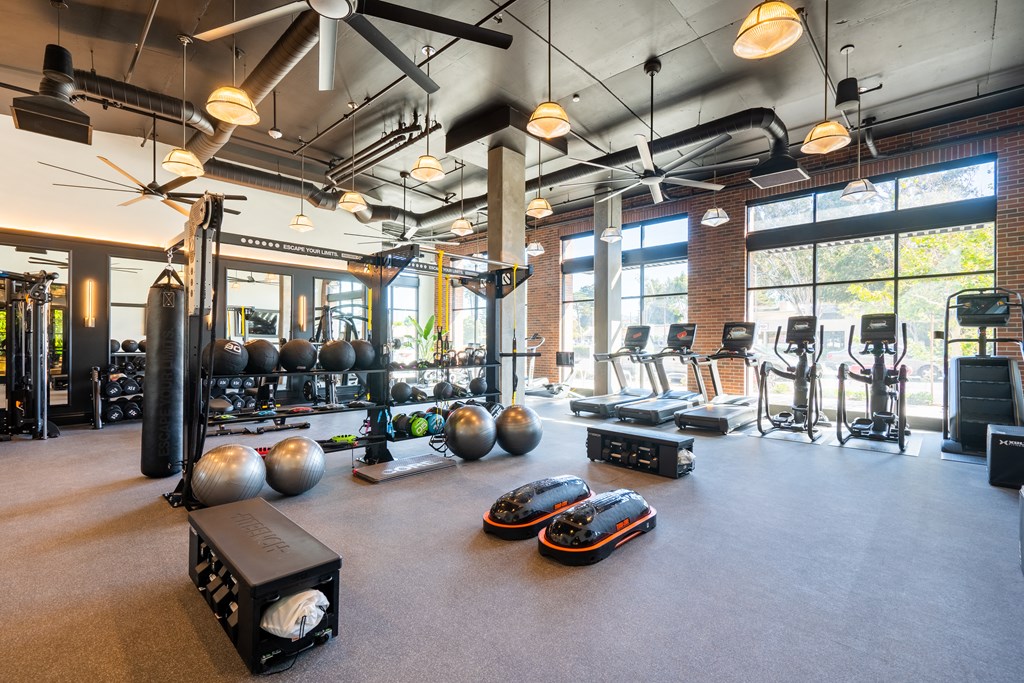 a gym with weights and other exercise equipment and windows