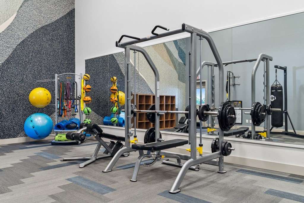 a fitness room with weights and other gym equipment