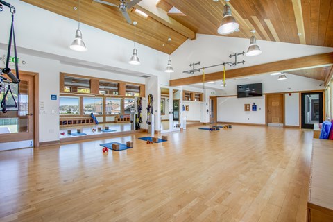 A gym with wooden floors and a high ceiling.