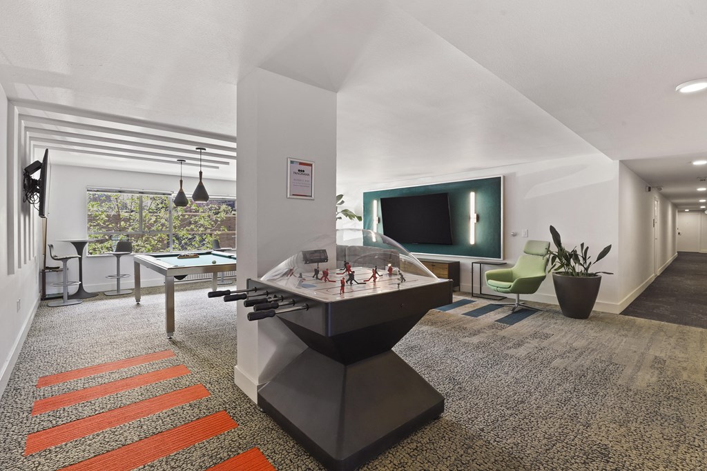 a living room with a pool table and a television