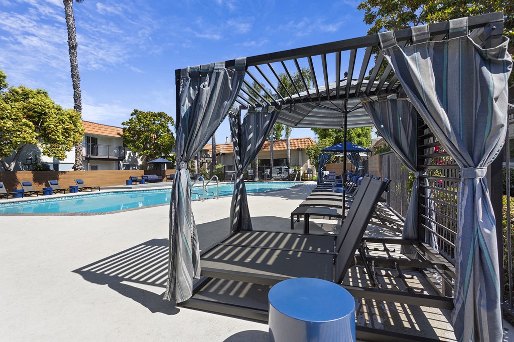 a pool with lounge chairs and umbrellas