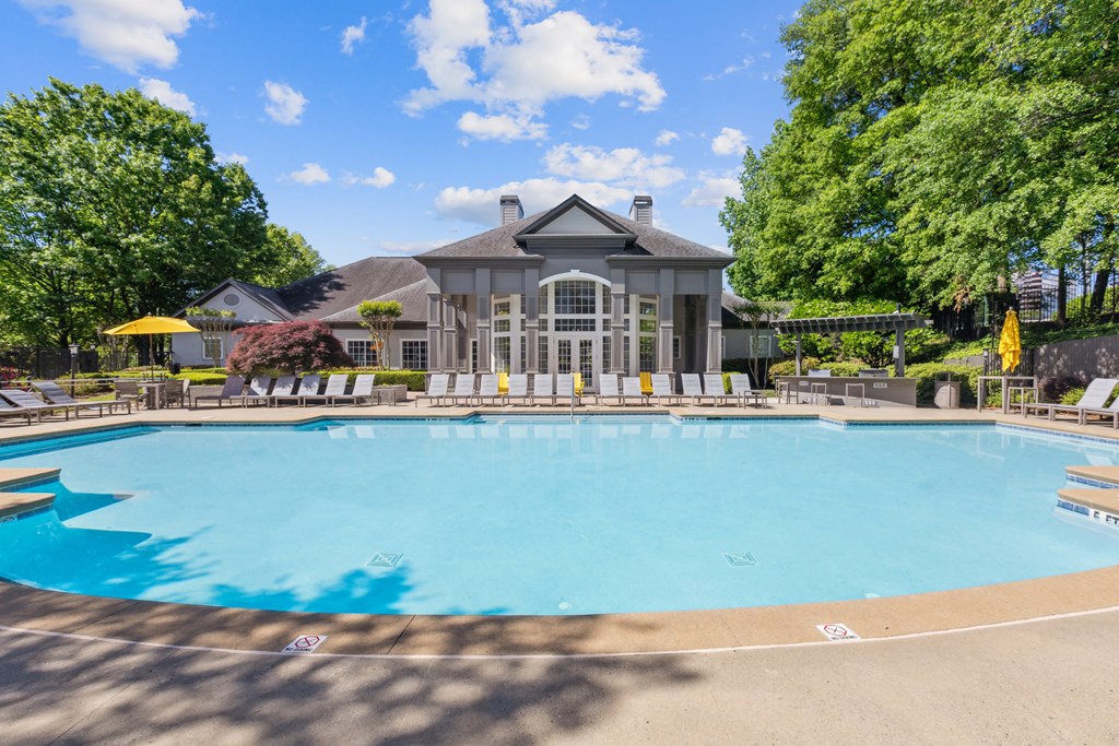 a swimming pool with a house in the background