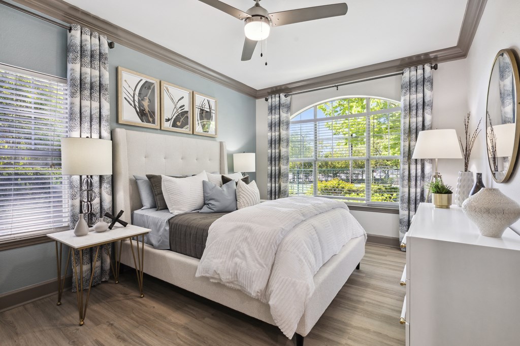 a bedroom with a bed and a large window