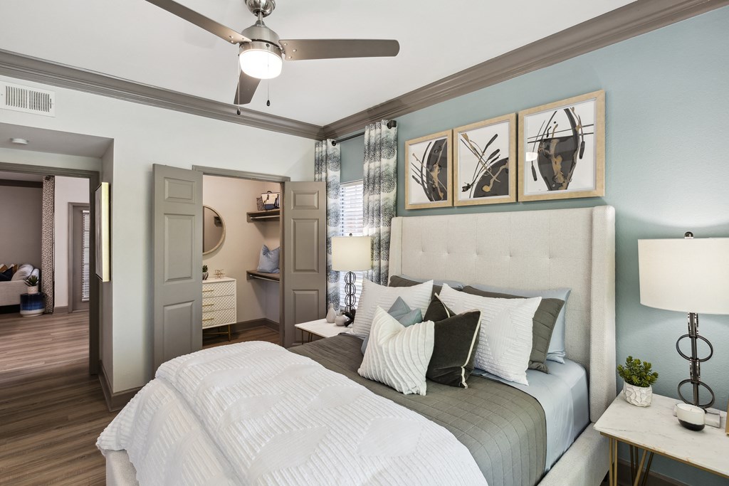 a bedroom with a large bed and a ceiling fan