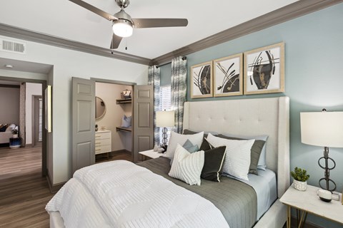 a bedroom with a large bed and a ceiling fan