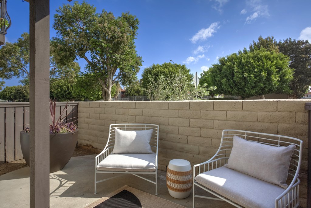 a patio with two chairs and a table