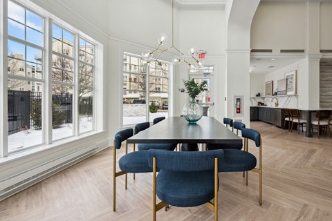 a dining room with a long table and blue chairs
