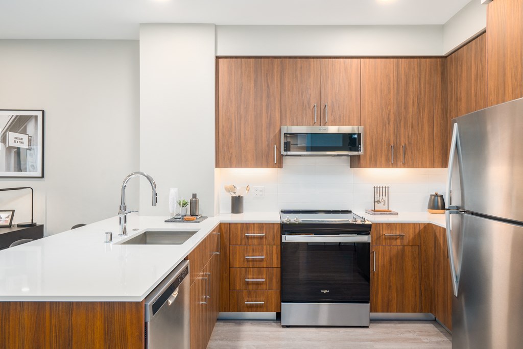 a kitchen with wooden cabinets and stainless steel appliances