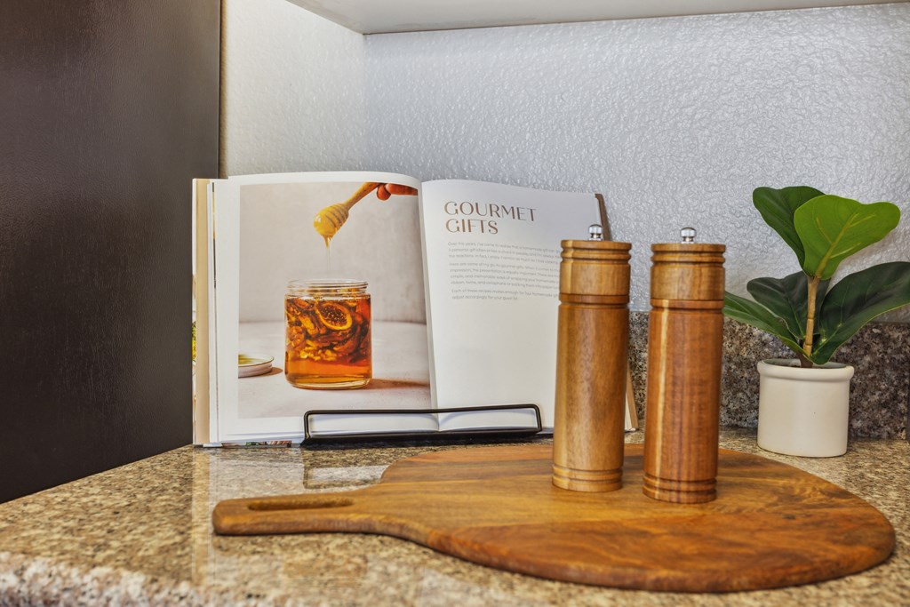 a book sitting on a counter next to a wooden cutting board