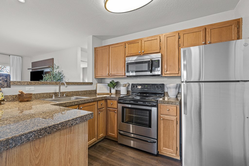 a kitchen with stainless steel appliances and granite counter tops