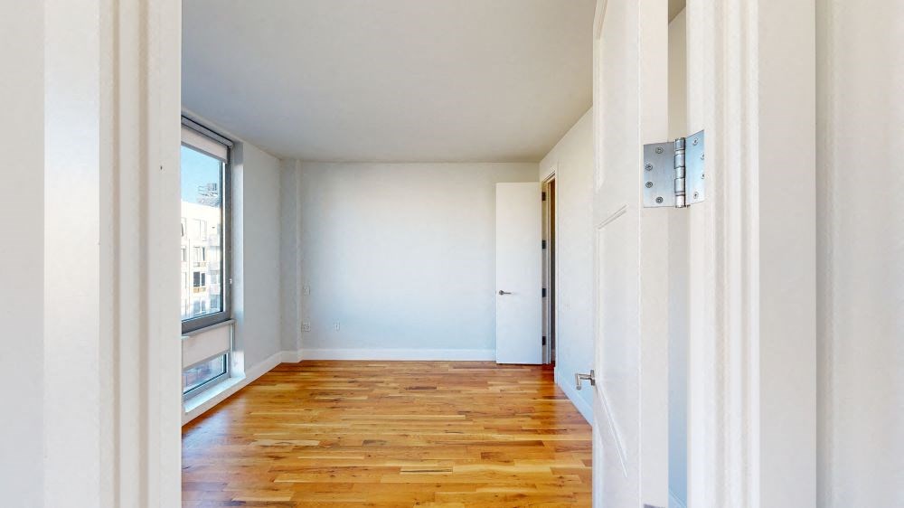 A room with wooden floors and white walls.