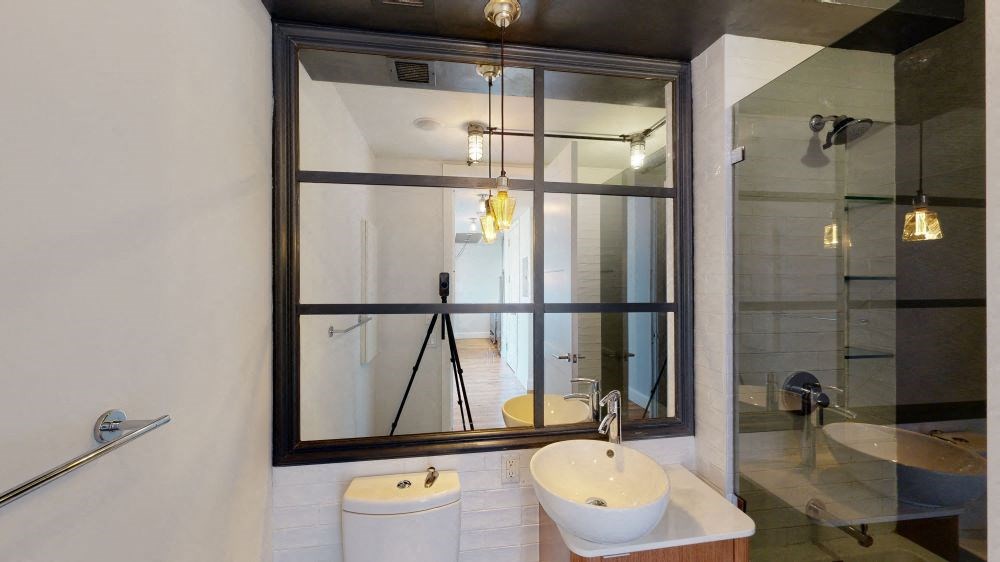 A bathroom with a white toilet and a white sink.
