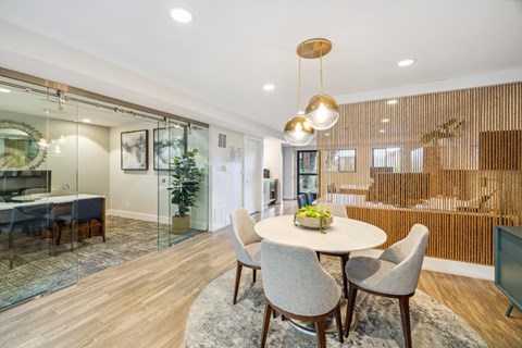 A modern leasing office with a glass table and chairs.