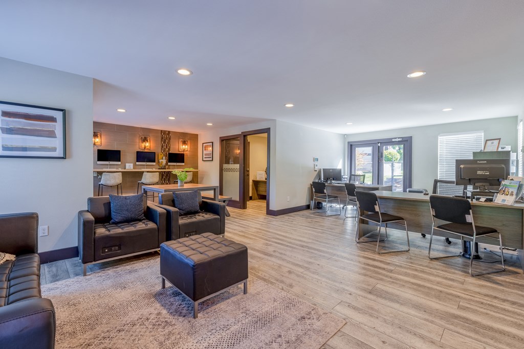 a living room with couches and chairs and a kitchen with a bar and a