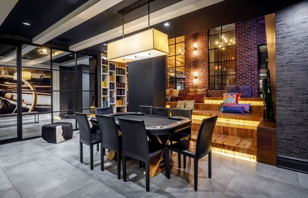 A modern dining room with a black table and chairs.