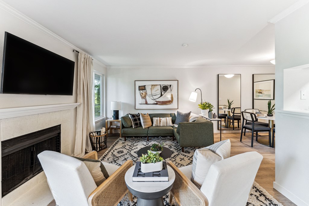 a living room with a couch and a table and a fireplace