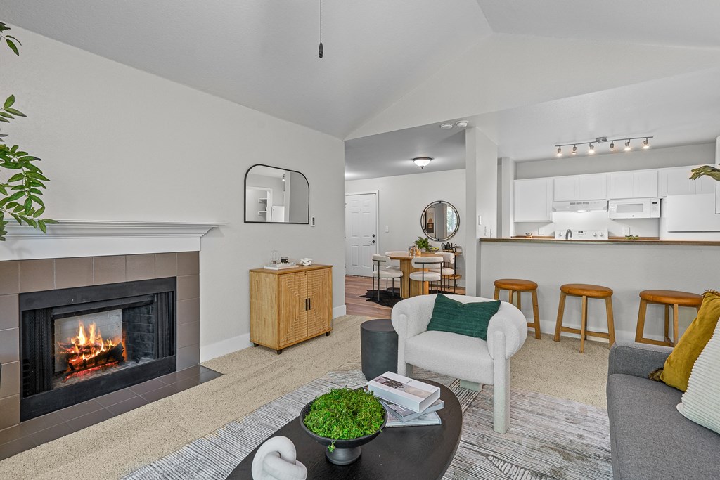a living room with a fireplace and a table with chairs