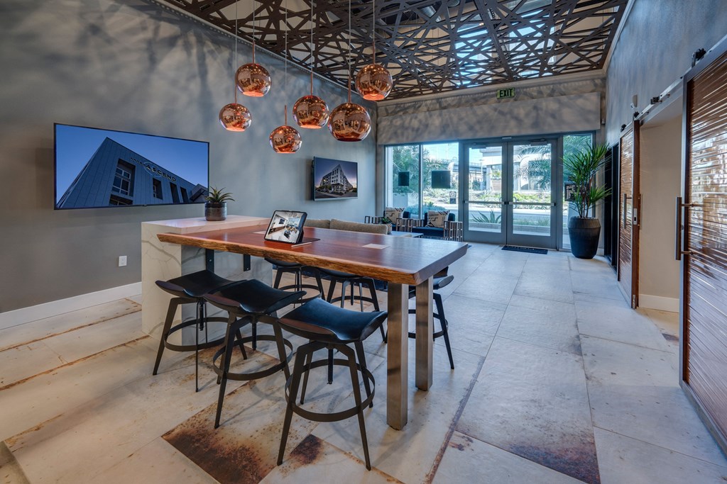 a dining room with a wooden table and bar stools
