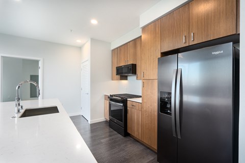 a kitchen with stainless steel appliances and a white counter top