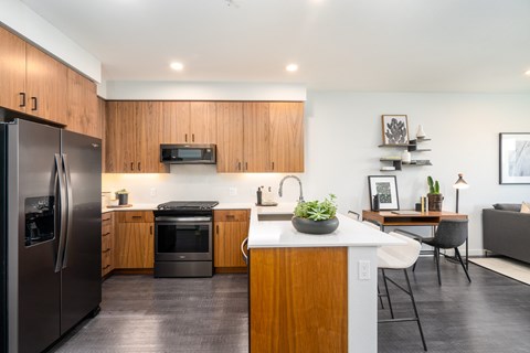 a kitchen with stainless steel appliances and wooden cabinetry