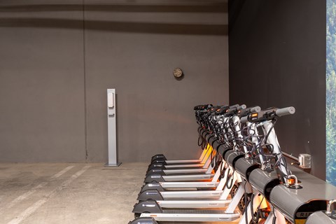 a row of bikes parked in front of a wall