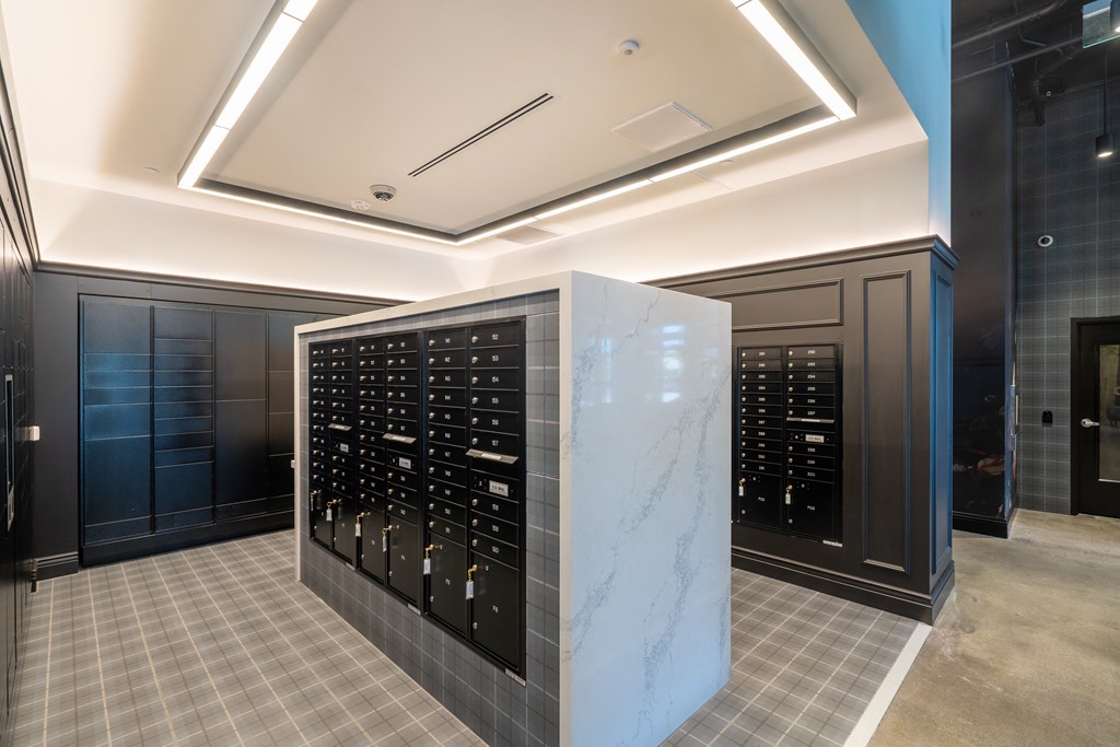 a large wine cellar with a marble wall and black cabinets