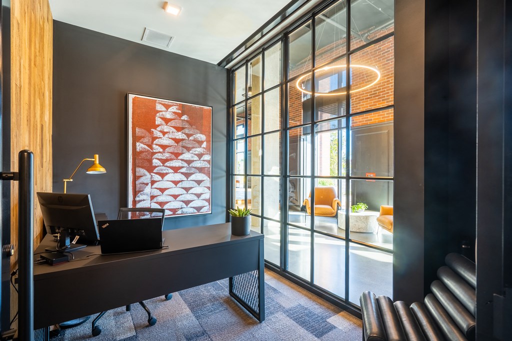 a desk in an office with glass doors
