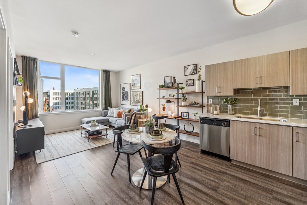an open living room with a kitchen and a dining table