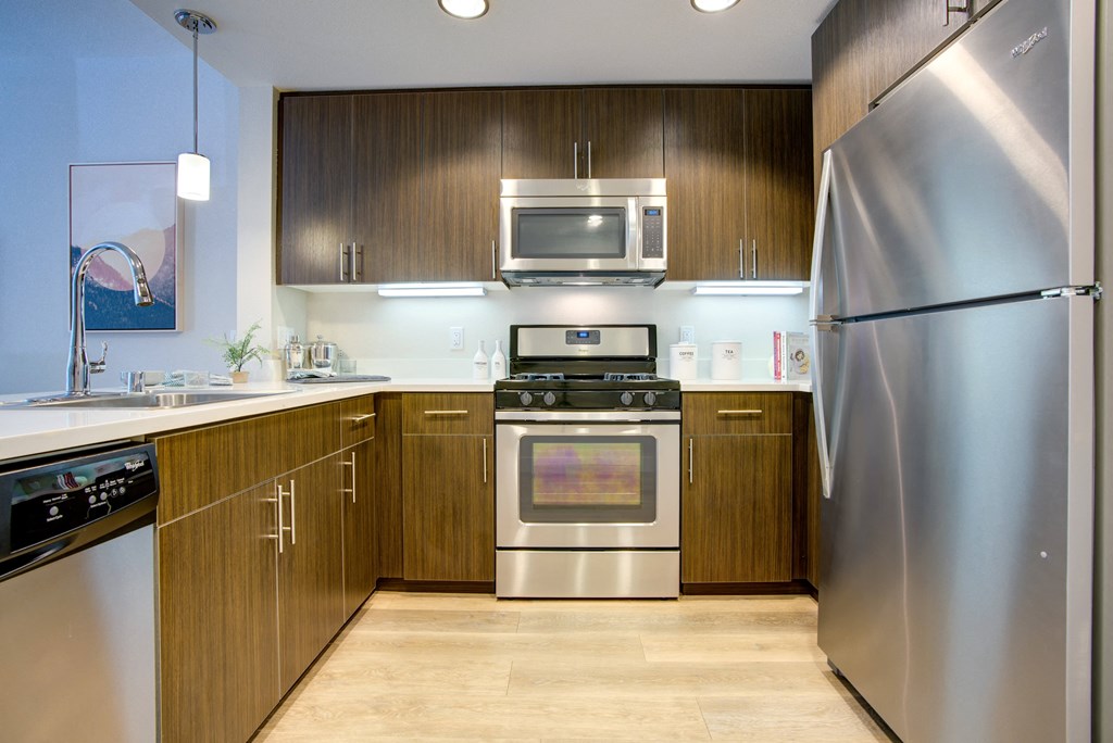 a kitchen with stainless steel appliances and wooden cabinets