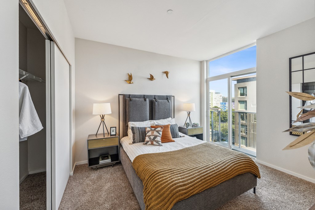 a bedroom with a large bed and a large window