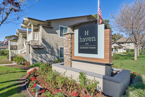 a house with a sign and an flag in front of it
