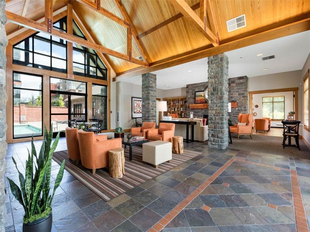 a large living room with couches and chairs and a fireplace