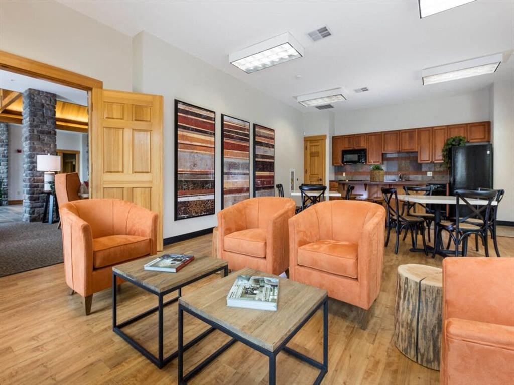 a living room with couches and chairs and a table