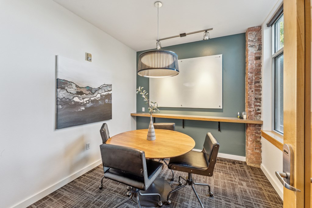 a dining room with a table and chairs and a large window